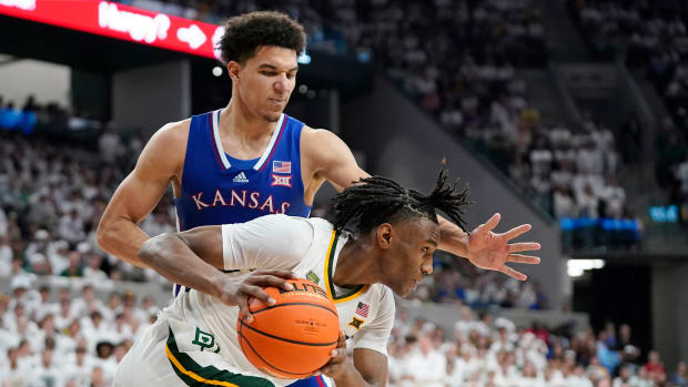 Mar 2, 2024; Waco, Texas, USA; Baylor Bears guard Ja'Kobe Walter (4) is defended by Kansas Jayhawks guard Kevin McCullar Jr. (15) during the second half at Paul and Alejandra Foster Pavilion. Mandatory Credit: Raymond Carlin III-USA TODAY Sports  